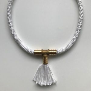 White rope necklace with brass piece and tassel